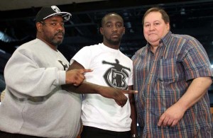 August 24, 2015,  Omaha, Nebraska  --- WBO Jr. Welterweight  champion Terence Crawford (ctr) (26-0, 18 KOs) attends a  press conference in Omaha, Nebraska Monday to announce his upcoming title defense against world-rated contender Dierry Jean (29-1, 20 KOs), from Montréal, Québec, Canada. Jean lost his passport and was unable to attend.     Promoted by Top Rank®, in association with Tecate, the Crawford vs. Jean championship fight will take place Saturday, October 24, at the CenturyLink Center. The championship event will be televised live on HBO World Championship Boxing®, beginning at 9:30 p.m. ET/PT. (L-R) Crawford co-managers:  Brian McIntyre and Cameron Dunkin.    ---   Photo Credit : Chris Farina - Top Rank (no other credit allowed)  copyright 2015
